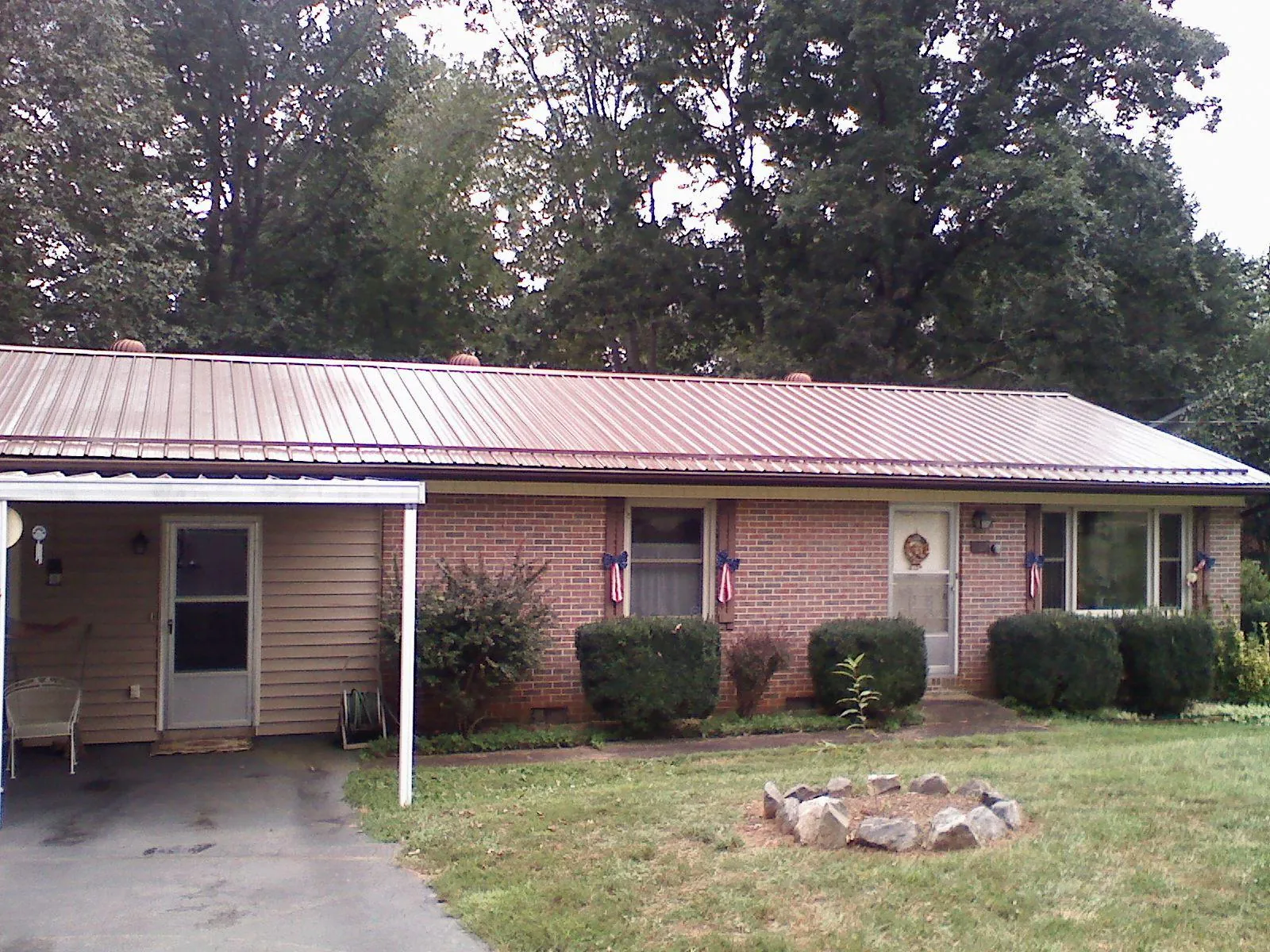 Bronze metal roof and carport on a brick ranch home — Roof Repair work by our crew in Carlton
